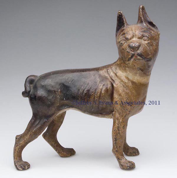 BOSTON TERRIER FACING RIGHT CAST-IRON DOORSTOP: BOSTON TERRIER FACING RIGHT CAST-IRON DOORSTOP, medium size, hollow full figure, original paint. Possibly Hubley. First half 20th century. 9 3/4" H, 9" L. Provenance: From a New Jersey estate collecti