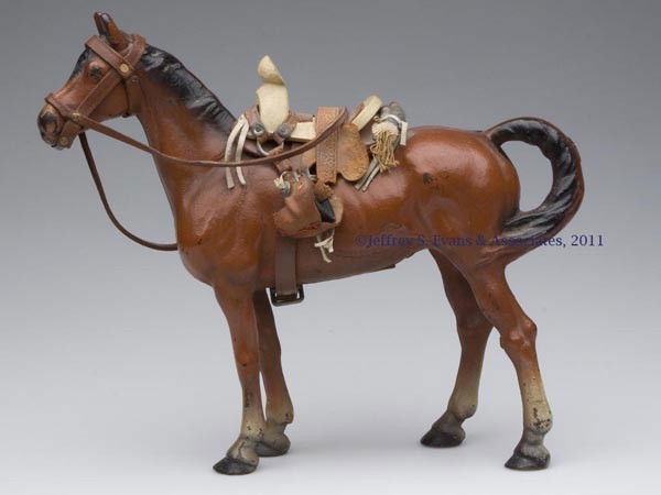 HORSE CAST-IRON DOORSTOP: HORSE CAST-IRON DOORSTOP, hollow full figure with saddle and tack, original paint. Hubley #345. First half 20th century. 10 3/4" H, 11 1/4" L. Provenance: From a New York estate.