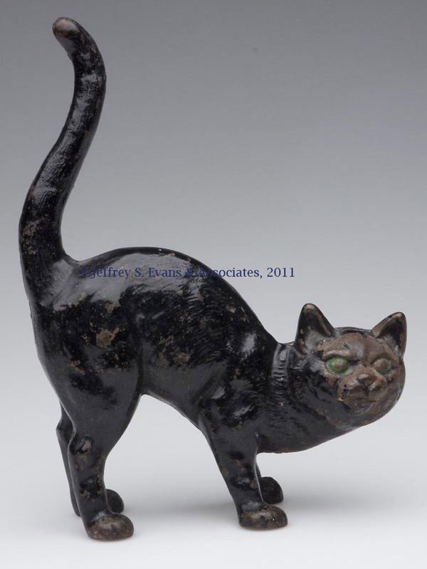 HUNCHBACK BLACK CAT CAST-IRON DOORSTOP: HUNCHBACK BLACK CAT CAST-IRON DOORSTOP, with tail in air, hollow full figure, original paint. Probably Hubley. First half 20th century. 10 1/2" H, 8" L. Provenance: From a Pennsylvania collection.
