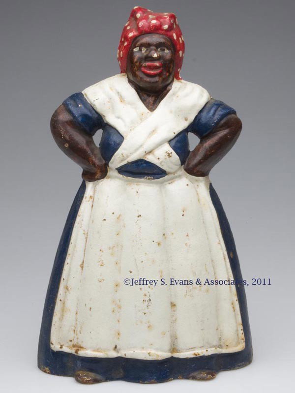 MAMMY WITH HANDS ON HIPS CAST-IRON DOORSTOP: MAMMY WITH HANDS ON HIPS CAST-IRON DOORSTOP, wedge half figure, original paint. Littco Products. Mid 20th century. 13" H, 8" W. Provenance: From a New York estate.