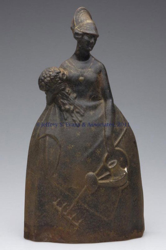 MARY QUITE CONTRARY CAST-IRON DOORSTOP: MARY QUITE CONTRARY CAST-IRON DOORSTOP, half figure, unpainted with remnants of gold highlights. First half 20th century. 15" H, 8" W. Provenance: From a New York estate.