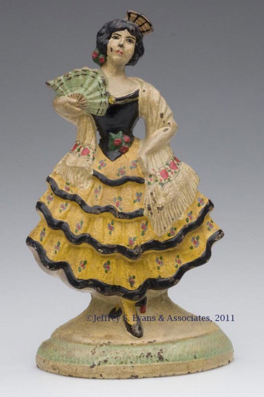 SPANISH GIRL CAST-IRON DOORSTOP: SPANISH GIRL CAST-IRON DOORSTOP, half figure, original paint, marked 193. Hubley. First half 20th century. 9" H, 5" W. Provenance: From a New York estate.