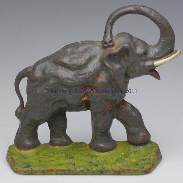 ELEPHANT CAST-IRON DOORSTOP: ELEPHANT CAST-IRON DOORSTOP, half figure, original paint. First half 20th century. 7 1/4" H, 7 1/2" W. Provenance: From a New York estate.