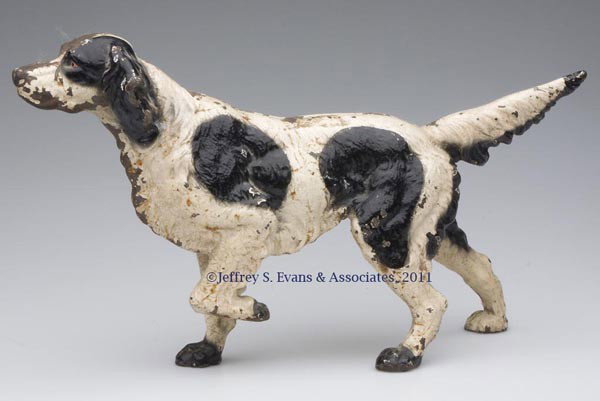 SETTER CAST-IRON DOORSTOP: SETTER CAST-IRON DOORSTOP, hollow full figure, original paint. Hubley #347. First half 20th century. 8 5/8" H, 15 1/2" L. Provenance: From a New York estate.