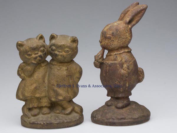 TWO ASSORTED ANIMAL FIGURAL CAST-IRON DOORSTOPS: TWO ASSORTED ANIMAL FIGURAL CAST-IRON DOORSTOPS, Peter Rabbit and Twin Kittens, each half figure with traces of paint. Probably Hubley. 20th century. 9 1/4" and 7 1/4" H. Provenance: From a New York e