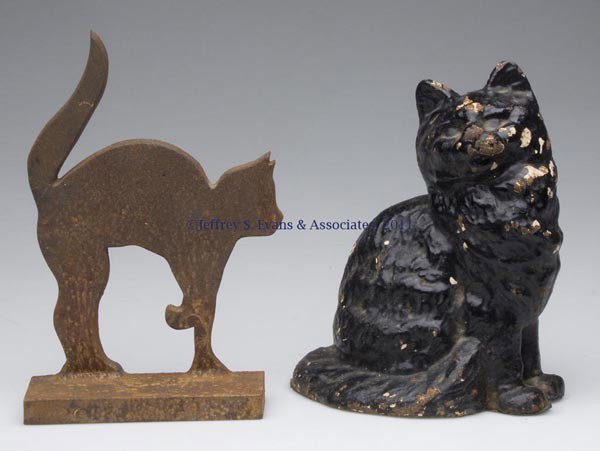 TWO ASSORTED CAT FIGURAL CAST-IRON DOORSTOPS: TWO ASSORTED CAT FIGURAL CAST-IRON DOORSTOPS, unpainted solid half figure and hollow full figure with original paint. 20th century. 9 1/4" and 8 1/2" H. Provenance: From a New York estate.