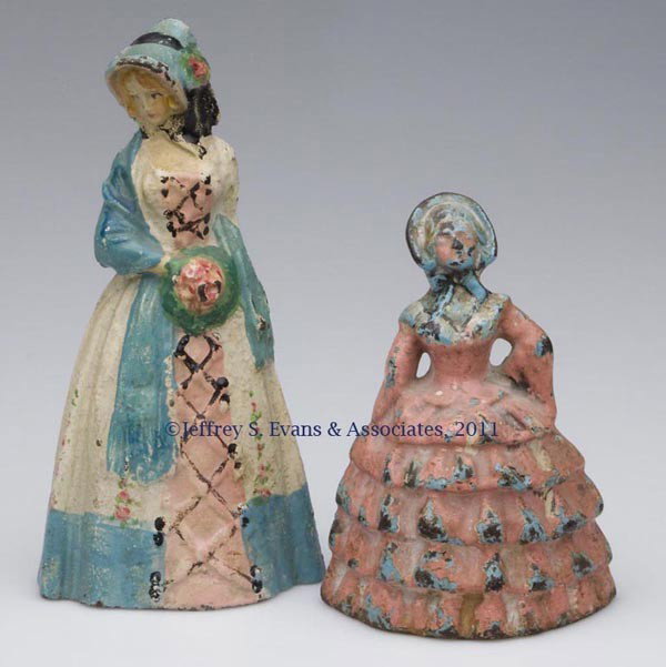 TWO ASSORTED COLONIAL LADY CAST-IRON DOORSTOPS: TWO ASSORTED COLONIAL LADY CAST-IRON DOORSTOPS, solid full figures, old paint. First half 20th century. 4 3/4" and 6 1/2" H. Provenance: From a New York estate.