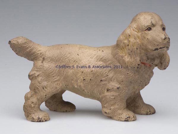 COCKER SPANIEL CAST-IRON DOORSTOP: COCKER SPANIEL CAST-IRON DOORSTOP, solid full figure, original paint. First half 20th century. 4 1/2" H, 6 3/4" L. Provenance: From a New York estate.