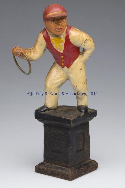 LAWN JOCKEY HITCHING POST CAST-IRON DOORSTOP: LAWN JOCKEY HITCHING POST CAST-IRON DOORSTOP, holding a ring, hollow full figure, original paint. 20th century. 11 3/4" H, 3 1/8" SQ base. Provenance: From a New York estate.