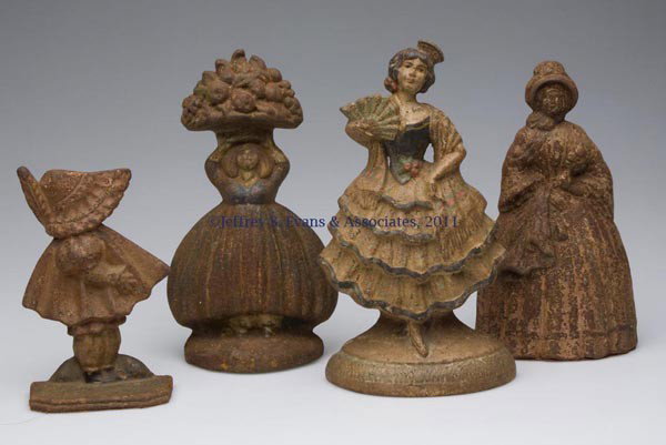 ASSORTED PEOPLE FIGURAL CAST-IRON DOORSTOPS, LOT O: ASSORTED PEOPLE FIGURAL CAST-IRON DOORSTOPS, LOT OF FOUR, each half figure with traces of original paint. First half 20th century. 6" to 9" H. Provenance: From a New York estate.
