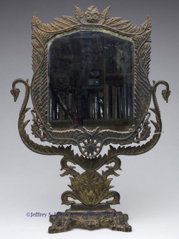 VICTORIAN CAST-IRON SWINGING SHAVING / TABLE TOP M: VICTORIAN CAST-IRON SWINGING SHAVING / TABLE TOP MIRROR, leaf and scroll form frame and rectangular form base, traces of gilt decoration. Second half 19th century. 19 1/2" H, 14" WOA.