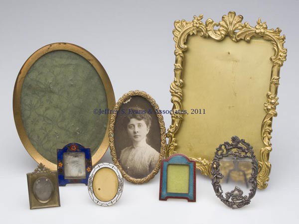 VARIOUS METAL FRAMES, LOT OF EIGHT: VARIOUS METAL FRAMES, LOT OF EIGHT, comprising three enameled examples, a sterling silver Foster & Bailey example with a lion and heavy scroll pattern, and four others. 19th and 20th centuries. Variou