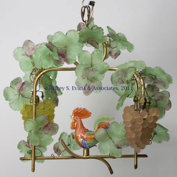 ITALIAN GLASS GRAPE VINE AND ROOSTER HANGING LAMP: ITALIAN GLASS GRAPE VINE AND ROOSTER HANGING LAMP, multi-color glass elements mounted on a gilt-metal frame, two grape bunches each with a single electric light bulb. Mid 20th century. 19" H, 22" WOA.