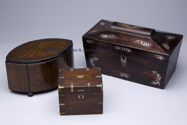 THREE ASSORTED WOODEN BOXES: THREE ASSORTED WOODEN BOXES, comprising a mother-of-pearl inlaid three-compartment tea caddy, an elliptical form trinket box with tray, and a brass bound humidor. 19th and 20th centuries. 4 1/4" x 5 1