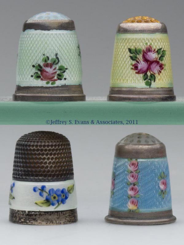 ENAMEL ON STERLING SILVER AND SILVER-LIKE THIMBLES: ENAMEL ON STERLING SILVER AND SILVER-LIKE THIMBLES, LOT OF FOUR, consisting of a sterling silver James Swan & Sons example with white ground and blue flowers, impressed on rim "BIRKS"; a yellow ground