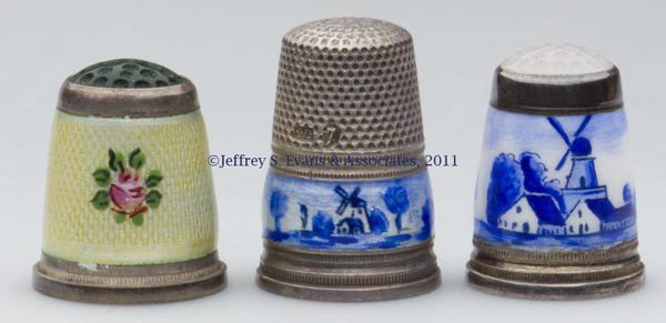 GERMAN ENAMEL ON STERLING SILVER THIMBLES, LOT OF : GERMAN ENAMEL ON STERLING SILVER THIMBLES, LOT OF THREE, consisting of two with blue and white Delft decoration, including a Gabler and a moonstone colored stone cap; and an example with yellow ground