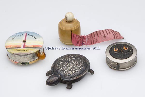 VARIOUS MATERIALS SEWING TAPE MEASURES, LOT OF FOU: VARIOUS MATERIALS SEWING TAPE MEASURES, LOT OF FOUR, comprising a metal turtle embossed "Pull My Head But Not My Leg"; a vegetable ivory example with stanhope, view of Sands & Railway Station Ramsgate