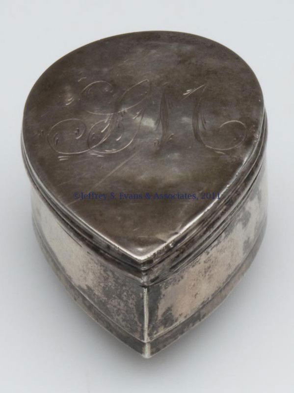 UNMARKED SILVER NUTMEG GRATER: UNMARKED SILVER NUTMEG GRATER, teardrop form with hinged lid opposite the inset punched sheet-iron grater, feathered "SM" monogram on lid. 18th or early 19th century. 1" H, 1 3/8" x 2". Provenance: Pr