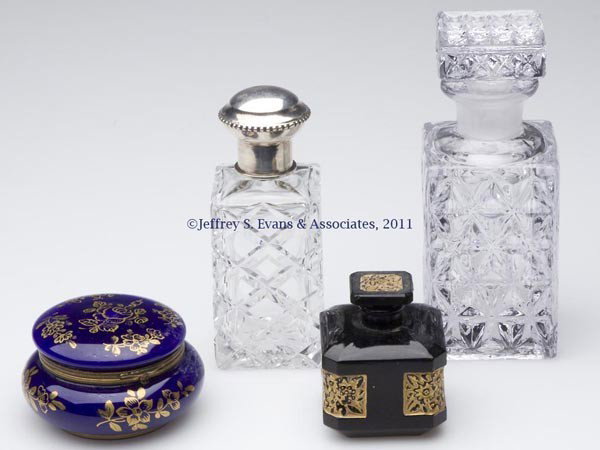 VARIOUS GLASS DRESSER ARTICLES, LOT OF FOUR: VARIOUS GLASS DRESSER ARTICLES, LOT OF FOUR, comprising a colorless pressed cologne with matching stopper, colorless cut cologne with inner stopper and European 824 silver fittings, an opaque black sq