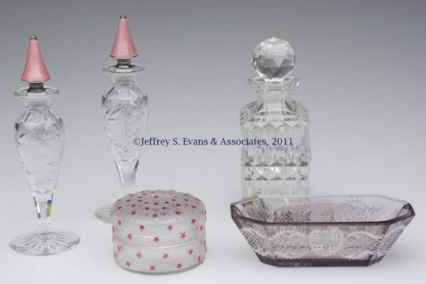 VARIOUS GLASS DRESSER ARTICLES, LOT OF FIVE: VARIOUS GLASS DRESSER ARTICLES, LOT OF FIVE, comprising a pair of stemmed cut glass cologne bottles, with marked "Sterling" silver and pink enamel guilloche-decorated stoppers/daubers, a cut-glass col
