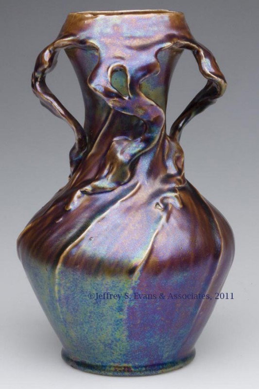 EUROPEAN METALLIC GLAZE ART POTTERY VASE, POSSIBLY: EUROPEAN METALLIC GLAZE ART POTTERY VASE, POSSIBLY ZSOLNAY, organic form with carved root-like protrusions from the rim to the shoulder, swirled rib body, impressed "7032" under base. Beautiful rich g