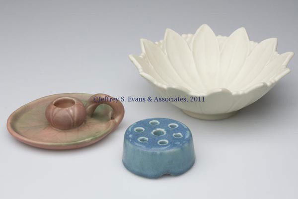 ROOKWOOD ART POTTERY ARTICLES, LOT OF THREE: ROOKWOOD ART POTTERY ARTICLES, LOT OF THREE, various color matte glazes, comprising a flori-form bowl, chamberstick, and flower frog, each with impressed mark on base. First half 20th century. Bowl 2