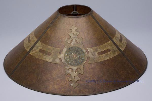 ART DECO MICA LAMP SHADE: ART DECO MICA LAMP SHADE, conical three-panel form with thin metal framing and applied cut-out and painted mica ornamentations. First half 20th century. 18" diameter, 6 1/2" H.
