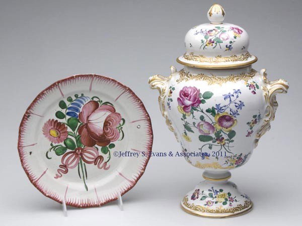 CONTINENTAL FAIENCE ARTICLES, LOT OF TWO: CONTINENTAL FAIENCE ARTICLES, LOT OF TWO, handpainted polychrome floral decoration, comprising a covered urn with elaborate gilding, and a plate with two holes for hanging, unmarked. 19th/20th century