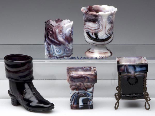 PURPLE SLAG GLASS TOOTHPICK HOLDERS, LOT OF FIVE: PURPLE SLAG GLASS TOOTHPICK HOLDERS, LOT OF FIVE, comprised of two square form with ring handle examples, one example fitted in a twisted wire stand; a British Boot/Boot & Spur; S Repeat; and a pedest
