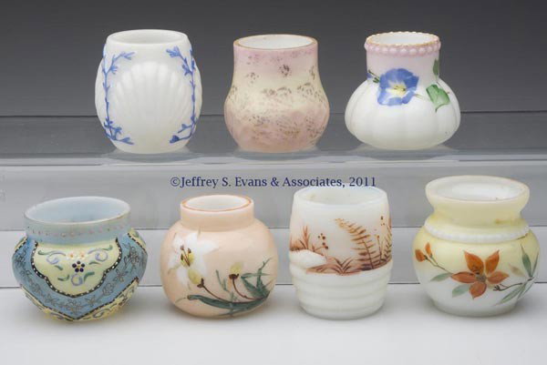 DECORATED OPAQUE WHITE GLASS TOOTHPICK HOLDERS, LO: DECORATED OPAQUE WHITE GLASS TOOTHPICK HOLDERS, LOT OF SEVEN, comprised of a Button & Bulge, a Coiling Serpent, Little Lobe, Painted Ball Base, Shell & Seaweed, a ball form with heavy enamel decoratio