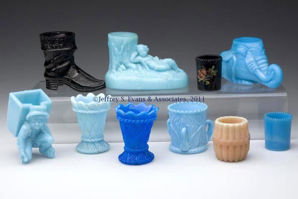 VARIOUS OPAQUE GLASS TOOTHPICK HOLDERS, LOT OF TEN: VARIOUS OPAQUE GLASS TOOTHPICK HOLDERS, LOT OF TEN, comprised of an opaque blue Boy with Pack, Elephant Head, Late Swan, Wicker Basket in light and starch blue with one having embossed base "SV", and