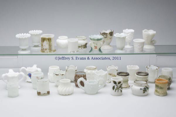 VARIOUS PATTERNS OPAQUE WHITE GLASS TOOTHPICK / MA: VARIOUS PATTERNS OPAQUE WHITE GLASS TOOTHPICK / MATCH HOLDERS, LOT OF 35, twenty with worn polychrome or gilt decoration, including a Forget-Me-Not, a Guttate, a Mt. Washington Swirled with satin fini