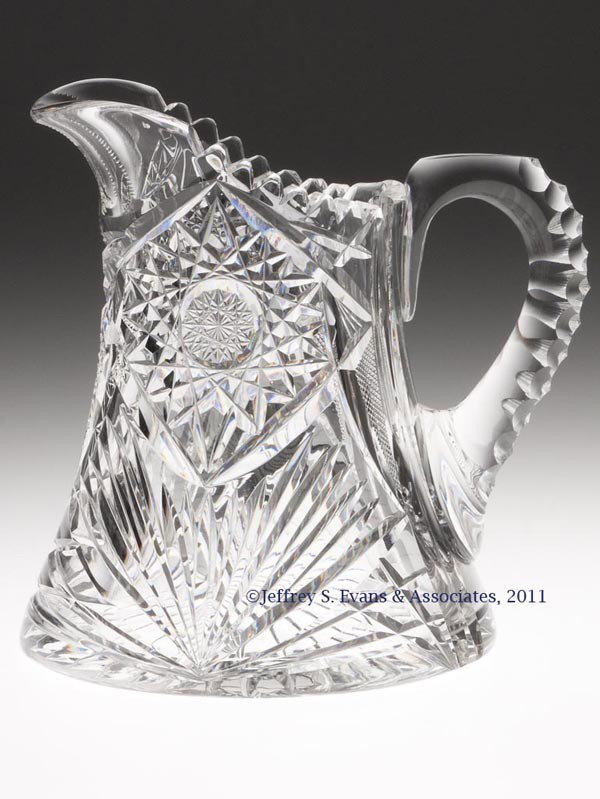 FRY BRILLIANT CUT GLASS WATER PITCHER: FRY BRILLIANT CUT GLASS WATER PITCHER, featuring hobstars, fans and a notched-cut handle, signed under base. H. C. Fry Glass Co. Late 19th/early 20th century. 7 7/8" H, 6 3/4" DOA. Provenance: From th