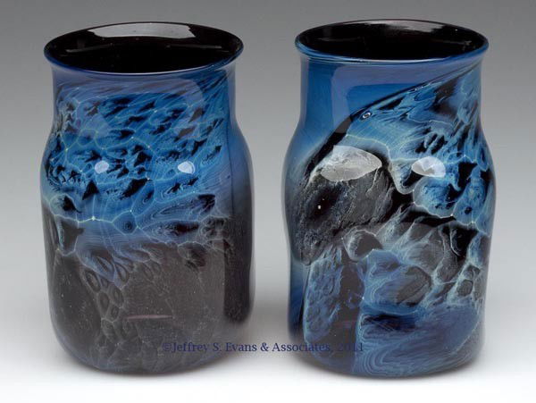 JOSH SIMPSON STUDIO ART GLASS "BLUE NEW MEXICO" PAI: JOSH SIMPSON STUDIO ART GLASS "BLUE NEW MEXICO" PAIR OF VASES, each with blue wind-swept design on a transparent amethyst base, rough pontil mark, signed and undated. Second half 20th century. 4 1/2"