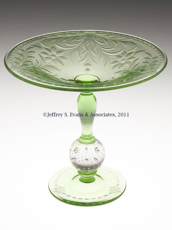 PAIRPOINT ENGRAVED GLASS COMPORT: PAIRPOINT ENGRAVED GLASS COMPORT, green with colorless bubble ball, shape B-366, Unknown B decoration, polished pontil mark. Pairpoint Corp. First half 20th century. 6" H, 6 1/2" D. Provenance: From t