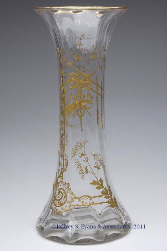 RIB-OPTIC GLASS VASE: RIB-OPTIC GLASS VASE, colorless, with heavy gilt decoration, and polished pontil mark. Probably European. Late 19th/early 20th century. 15 3/4" H, 7" DOA. Provenance: From the collection of Kenneth C.