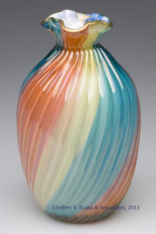 THOMAS WEBB AND SONS CASED RAINBOW GLASS VASE: THOMAS WEBB AND SONS CASED RAINBOW GLASS VASE, gilt decoration at rim, swirled rib body, polished pontil mark. Attributable to Thomas Webb and Sons. Fourth quarter 19th century. 6 1/2" H, 4" DOA.