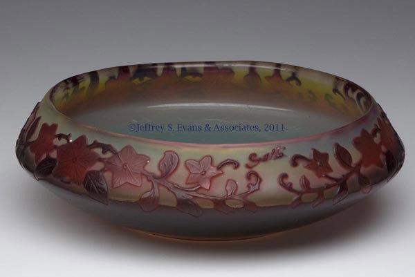 GALLE CAMEO GLASS BOWL: GALLE CAMEO GLASS BOWL, rose, maroon, and yellow, low-form with floral decorations around rim, signed, polished pontil mark. Early 20th century. 2" H, 6 3/4" DOA.