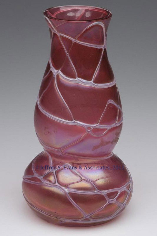 PALLME-KONIG RANDOM THREADED GLASS VASE: PALLME-KONIG RANDOM THREADED GLASS VASE, iridescent rose/red body with striped white decoration, factory polished rim. First quarter 20th century. 7 1/8" H. Provenance: Property of a Maryland collecto