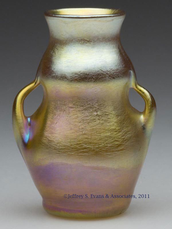 TIFFANY GOLD FAVRILE CABINET VASE: TIFFANY GOLD FAVRILE CABINET VASE, ribbed optic body with two pulled, side handles, signed "L.C.T.", "Favrile" and "5679A", polished pontil mark and table ring. Tiffany Studios. Early 20th century. 2