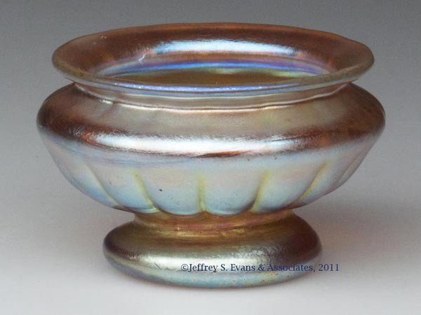 TIFFANY GOLD FAVRILE OPEN SALT: TIFFANY GOLD FAVRILE OPEN SALT, classical urn-form with vertical lobes, signed "L.C.T.", polished pontil mark and partial table ring. Tiffany Studios. Early 20th century. 1 1/2" H, 2 1/4" D rim. Prove