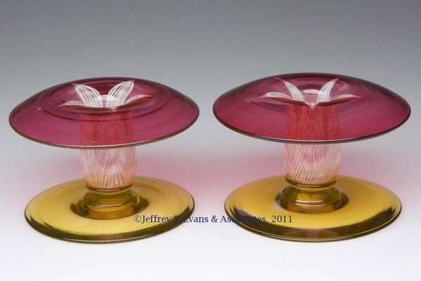 DURAND PEACOCK FEATHER PAIR OF CANDLE HOLDERS: DURAND PEACOCK FEATHER PAIR OF CANDLE HOLDERS, ruby and colorless socket with opal and red decoration, raised on a yellow lustre foot with a polished pontil mark, not signed. Vineland Flint Glass Work