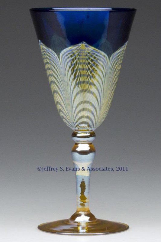 DURAND PEACOCK FEATHER GOBLET: DURAND PEACOCK FEATHER GOBLET, blue and Spanish yellow conical bowl with opal and blue decoration, raised on a yellow lustre stem and foot with a polished pontil mark, not signed. Vineland Flint Glass