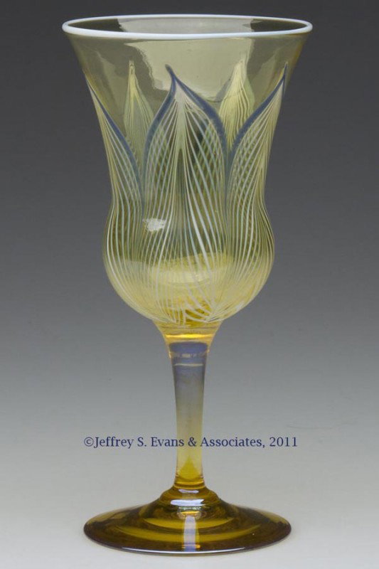 DURAND PEACOCK FEATHER GOBLET: DURAND PEACOCK FEATHER GOBLET, Spanish yellow bowl with opal and blue decoration, applied opal rim, raised on a yellow lustre stem and foot with a polished pontil mark, not signed. Vineland Flint Glas