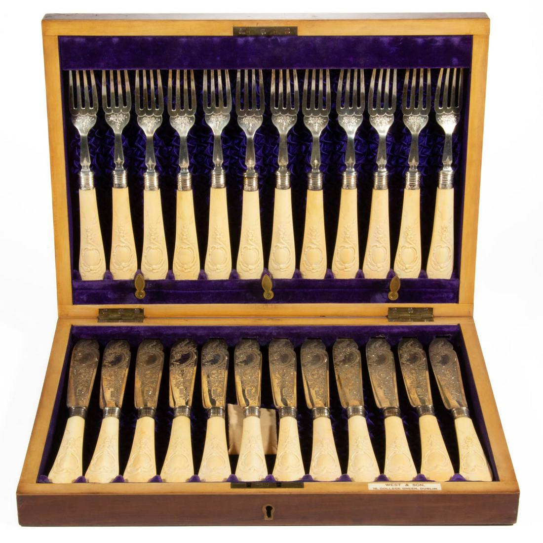 ENGLISH STERLING SILVER AND CARVED BONE 24-PIECE FISH FORK AND KNIFE SET: ENGLISH STERLING SILVER AND CARVED BONE 24-PIECE FISH FORK AND KNIFE SET, each piece having a sterling silver blade or tines with engraved decoration on a carved bone handle with sterling bolster, com