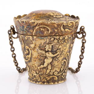 DUTCH GILT 0.833 SILVER SEWING CHATELAINE THIMBLE CASE APPENDAGE: DUTCH GILT 0.833 SILVER SEWING CHATELAINE THIMBLE CASE APPENDAGE, tapered bucket form with hinged lid, bas-relief ornamentation depicting cherubs within netting and scrolls on the sides of base,