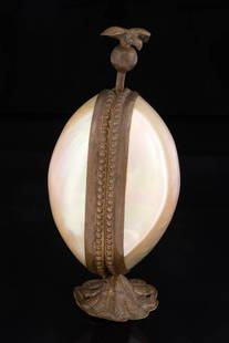 FRENCH GILDED BRASS, BRONZE, AND MOTHER-OF-PEARL FIGURAL SEWING NEEDLEWORKING ETUI / TOOL HOLDER: FRENCH GILDED BRASS, BRONZE, AND MOTHER-OF-PEARL FIGURAL SEWING NEEDLEWORKING ETUI / TOOL HOLDER, egg-form container constructed of two mother-of-pearl halves with a figural bronze eagle push-down