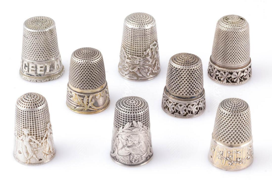 ASSORTED FRENCH SILVER SEWING THIMBLES, LOT OF EIGHT: ASSORTED FRENCH SILVER SEWING THIMBLES, LOT OF EIGHT, each bearing French hallmark, including an example with vignettes of a lady sewing, a man at his lathe, and a WWI French soldier aiming his gun si