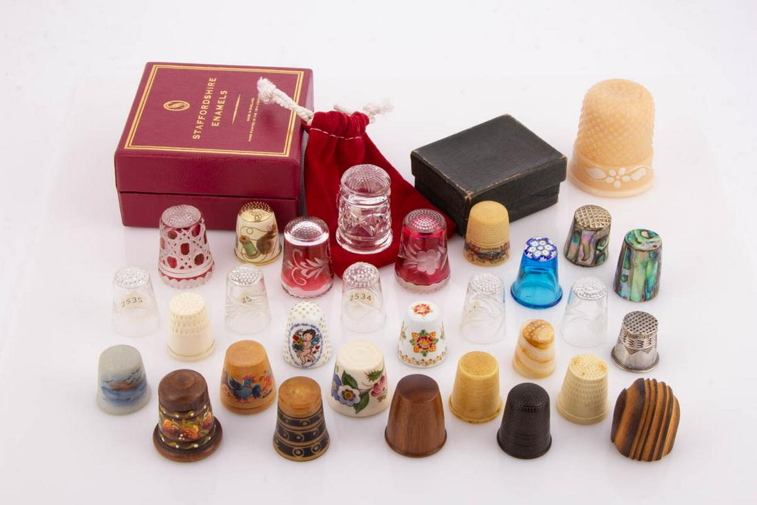 VARIOUS MATERIALS SEWING THIMBLES: VARIOUS MATERIALS SEWING THIMBLES, uncounted lot, including blue glass Caithness paperweight-top, five colorless glass with engraved differing decorations to bands thought to be by the Cambridge Glass