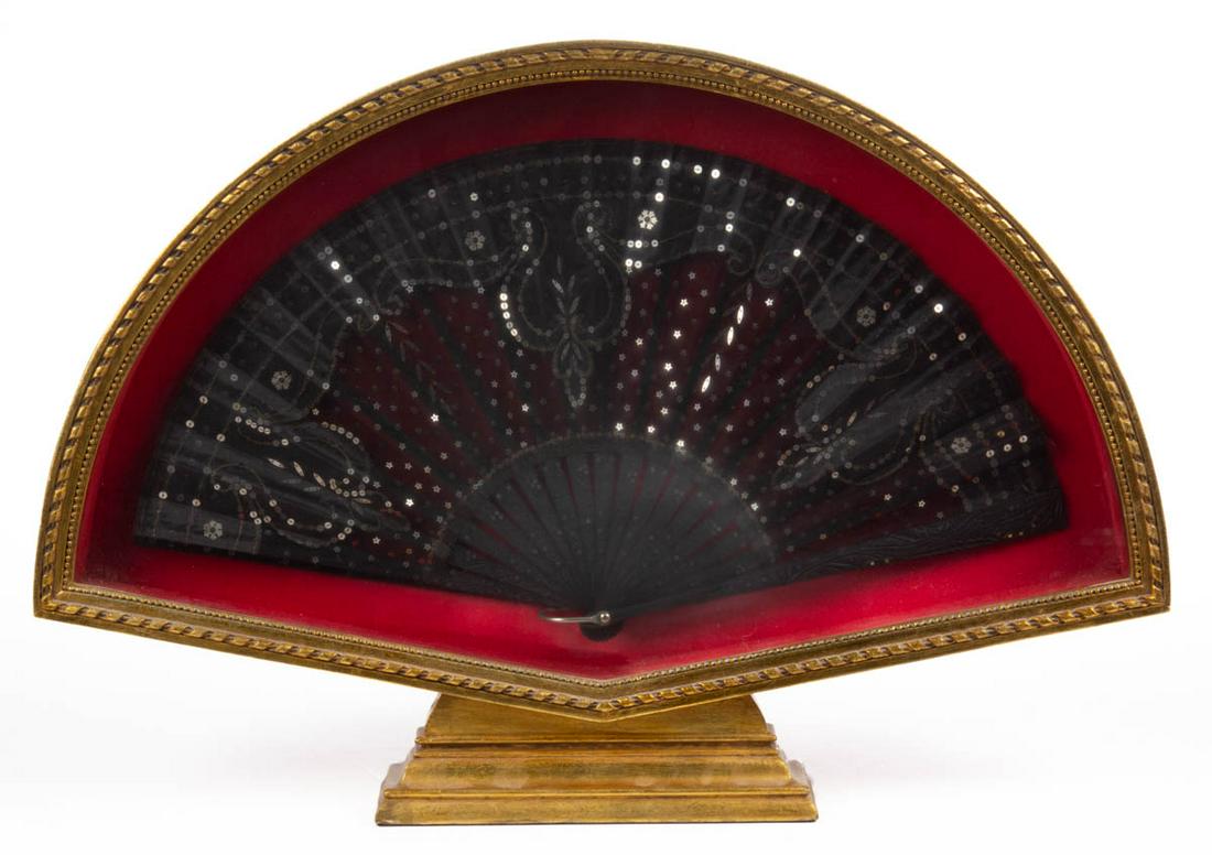 VICTORIAN / EDWARDIAN HAND FAN: VICTORIAN / EDWARDIAN HAND FAN, having black handles with carved decoration and metal inlay, black fabric fan decorated with metal spangles/sequins including star form and snowflake form. Housed under